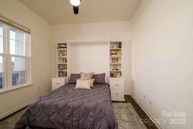 bedroom featuring ceiling fan and dark wood-type flooring