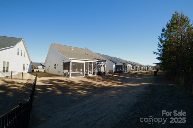 back of property with a sunroom