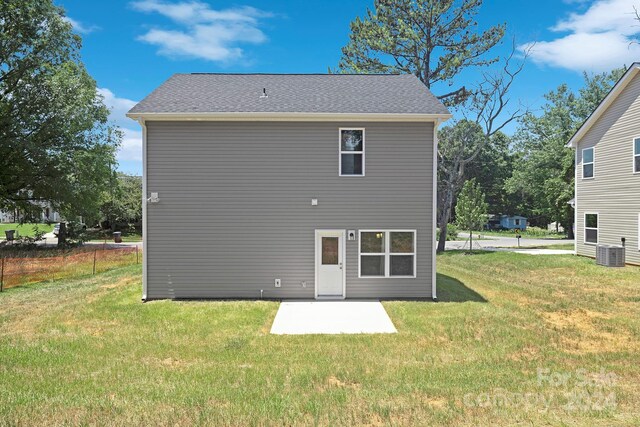 2612 Senior Dr, Charlotte, NC 28216 - rear view of property featuring a patio area, a lawn, central AC unit, and roof with shingles