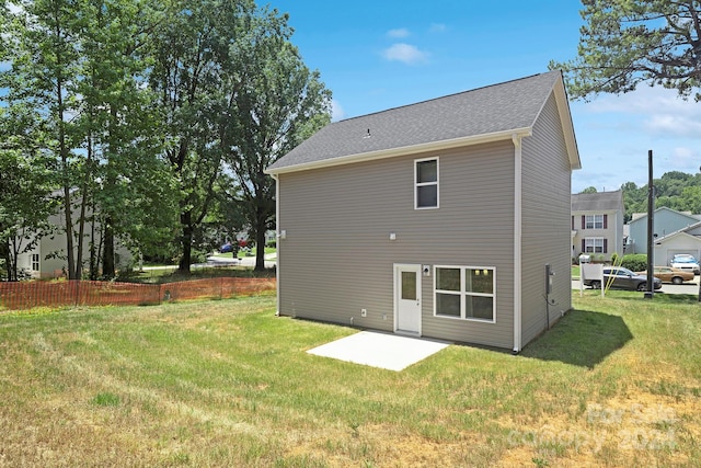 rear view of house featuring a yard and a patio area