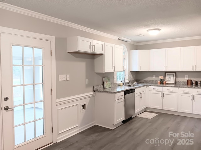 kitchen with dark stone counters, white cabinets, sink, stainless steel dishwasher, and a textured ceiling