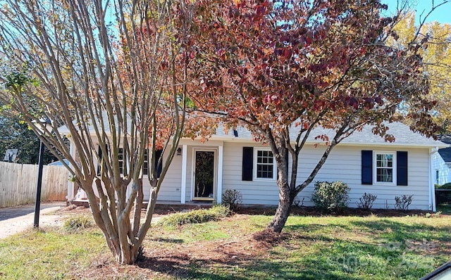 obstructed view of property featuring a front lawn