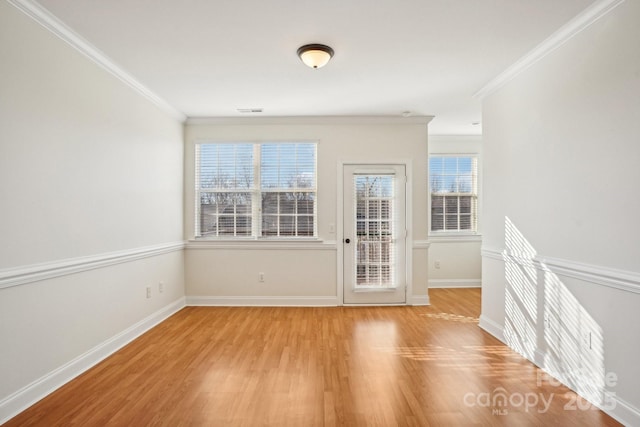 unfurnished room featuring ornamental molding and light hardwood / wood-style floors