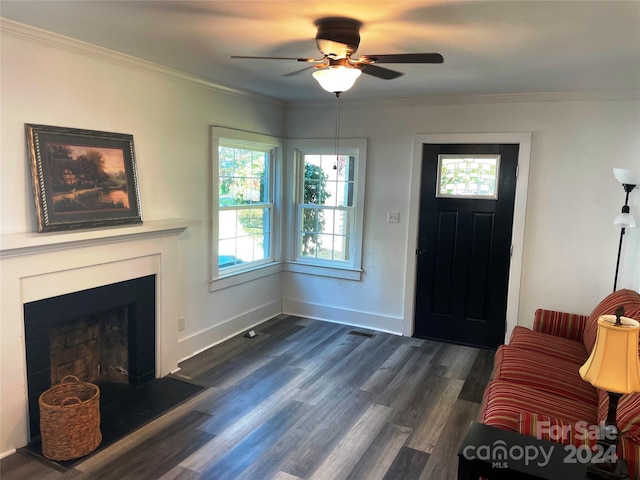 living room featuring dark hardwood / wood-style flooring, crown molding, ceiling fan, and plenty of natural light