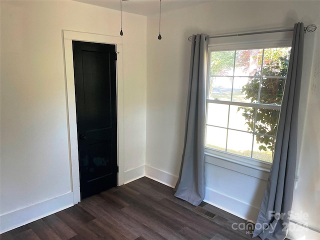 spare room featuring dark hardwood / wood-style floors