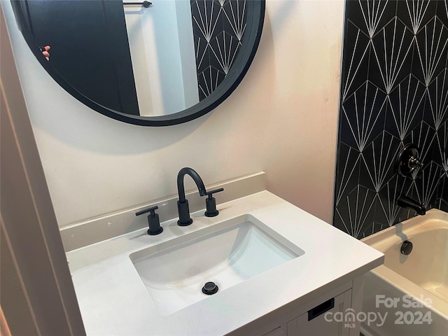 bathroom featuring vanity and a bathing tub