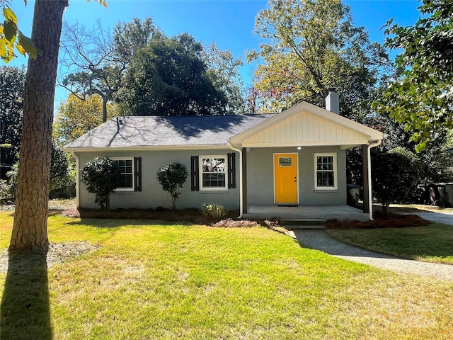 single story home with a front yard and covered porch