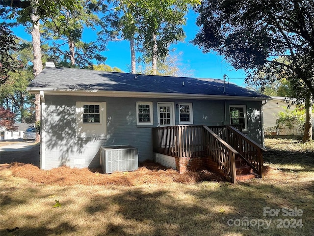 rear view of property with cooling unit