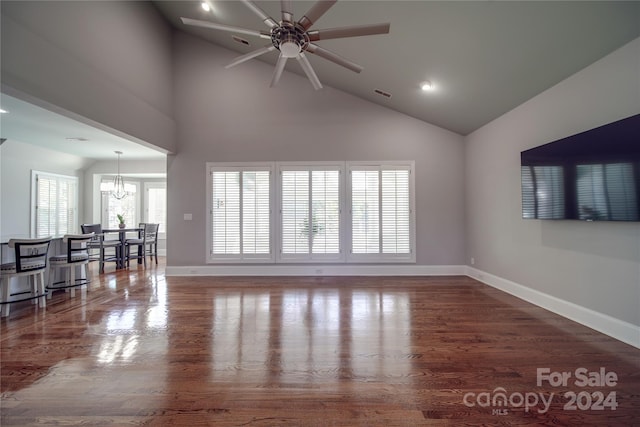 living room with high vaulted ceiling, dark hardwood / wood-style flooring, and ceiling fan with notable chandelier