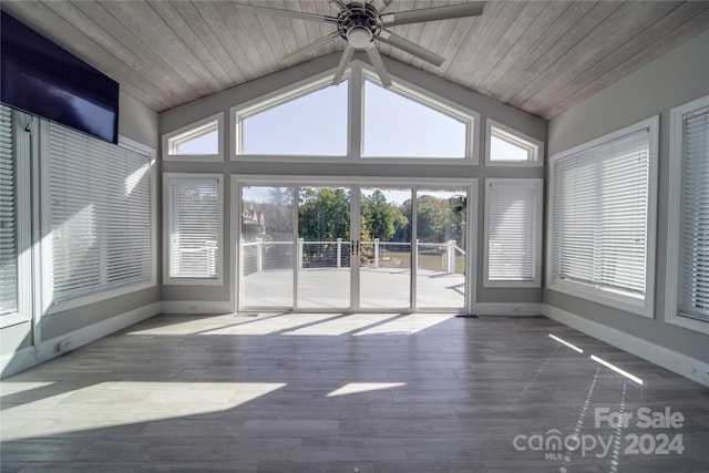 unfurnished sunroom featuring lofted ceiling, ceiling fan, wooden ceiling, and a wealth of natural light