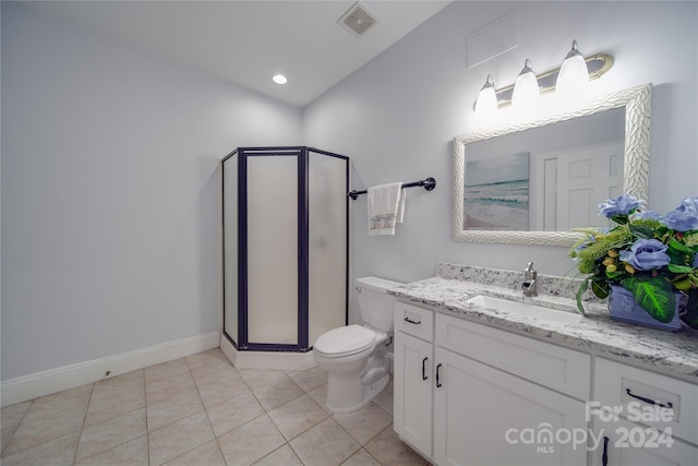 bathroom featuring vanity, tile patterned flooring, toilet, and walk in shower