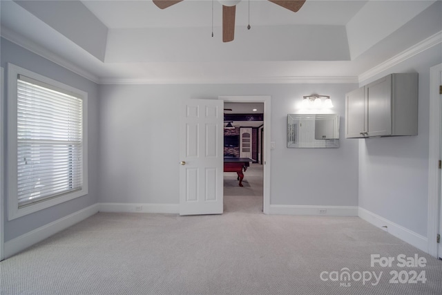 empty room with crown molding, billiards, light colored carpet, and ceiling fan