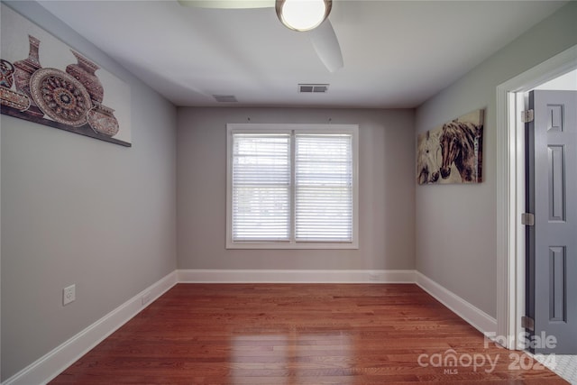 empty room featuring hardwood / wood-style flooring and ceiling fan