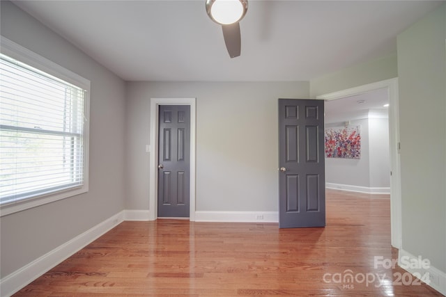 unfurnished room featuring light hardwood / wood-style floors and ceiling fan