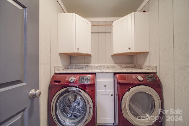 laundry area featuring washer and dryer, crown molding, and cabinets