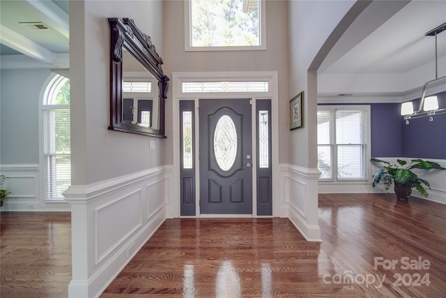 entryway with dark wood-type flooring and a high ceiling