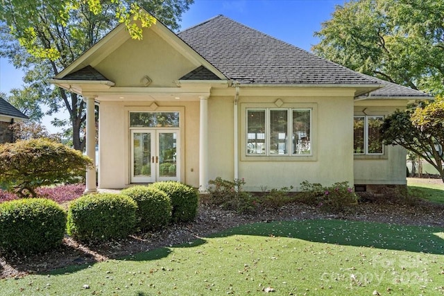 exterior space featuring french doors and a yard