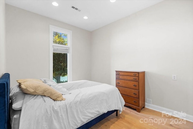 bedroom with wood-type flooring