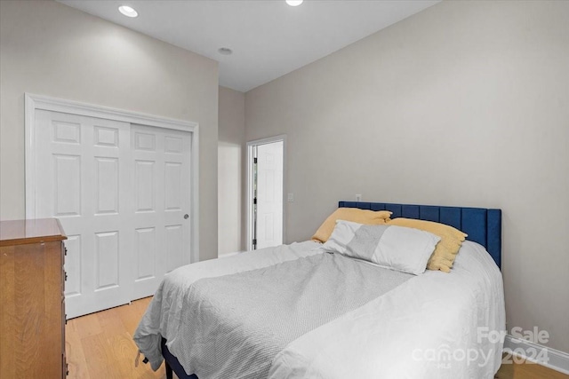 bedroom with a closet and light hardwood / wood-style floors