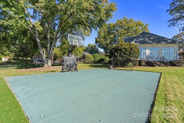 view of sport court featuring a yard