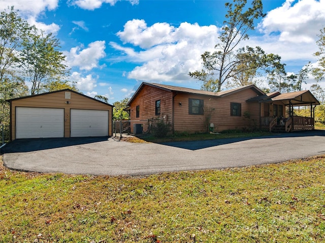 24 Palatka St, Arden, NC 28704 - view of side of property featuring an outbuilding, a garage, covered porch, and central AC unit