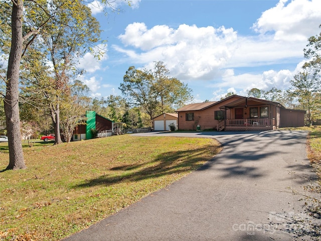 single story home featuring a garage, a front lawn, and a porch