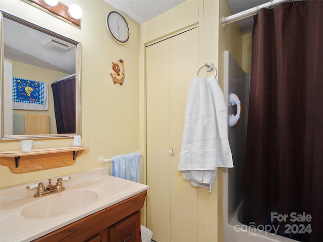 24 Palatka St, Arden, NC 28704 - bathroom featuring a textured ceiling, vanity, and curtained shower