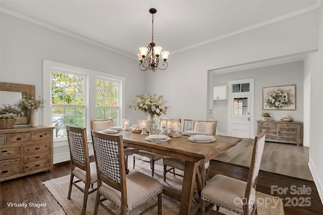 dining space featuring a chandelier, dark wood finished floors, and crown molding