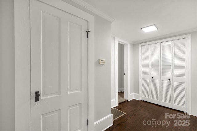 interior space featuring baseboards, dark wood finished floors, and a closet