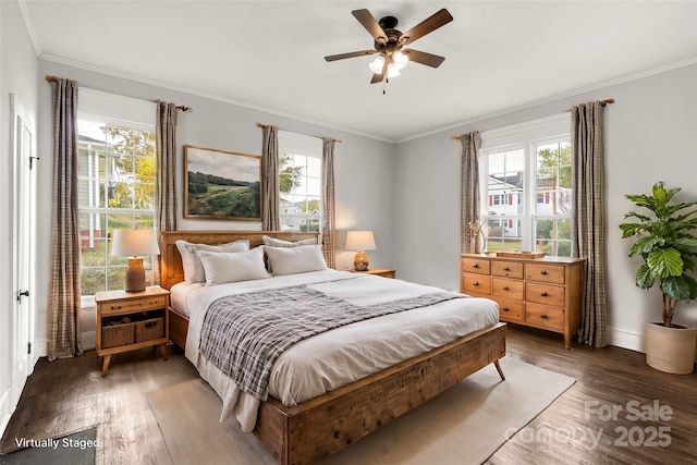 bedroom featuring ceiling fan, dark wood-type flooring, baseboards, and crown molding