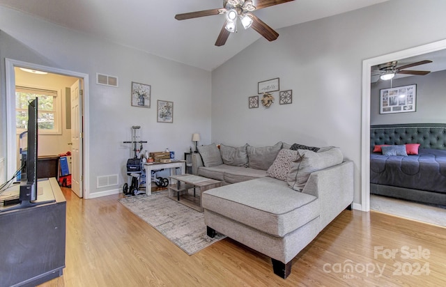 living room with lofted ceiling, wood-type flooring, and ceiling fan