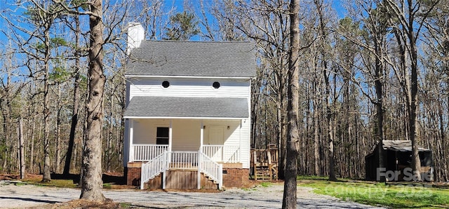 1062 Full Count Ln, Lancaster, SC 29720 - view of front facade with roof with shingles, covered porch, stairs, a chimney, and a shed