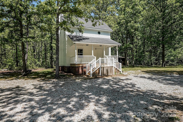 1062 Full Count Ln, Lancaster, SC 29720 - view of front facade with a porch, stairway, roof with shingles, and a forest view