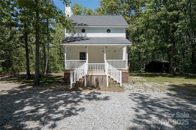1062 Full Count Ln, Lancaster, SC 29720 - view of front of house featuring a porch, stairway, roof with shingles, a chimney, and an outdoor structure