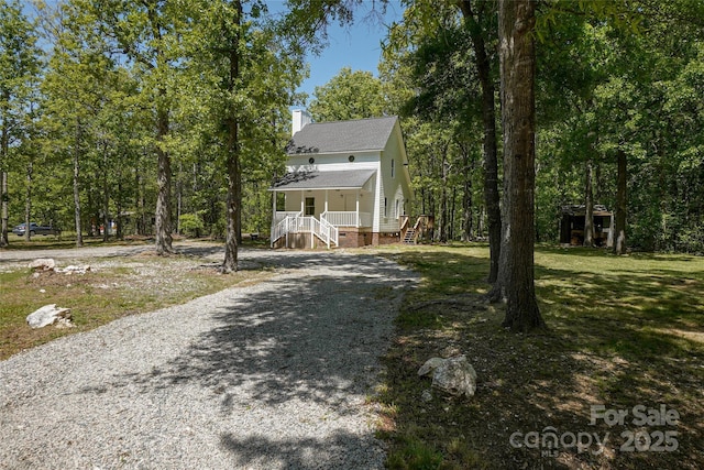 1062 Full Count Ln, Lancaster, SC 29720 - view of front of house with covered porch, a chimney, driveway, and roof with shingles
