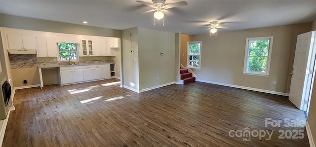 1062 Full Count Ln, Lancaster, SC 29720 - unfurnished living room with stairs, ceiling fan, a sink, dark wood-style flooring, and baseboards