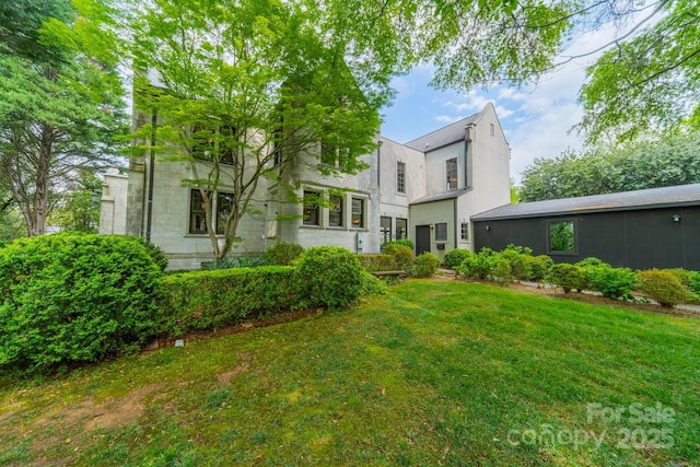 rear view of house with a lawn