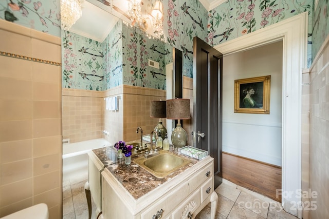 bathroom featuring wainscoting, tile patterned flooring, tile walls, and wallpapered walls