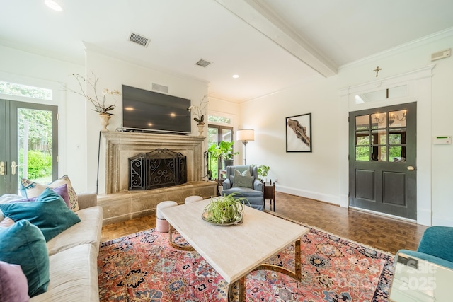 living area featuring french doors, visible vents, a premium fireplace, beamed ceiling, and baseboards