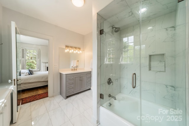 ensuite bathroom featuring ensuite bathroom, marble finish floor, vanity, and enclosed tub / shower combo