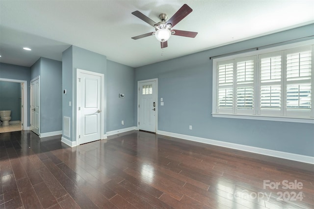 spare room featuring dark hardwood / wood-style floors and ceiling fan