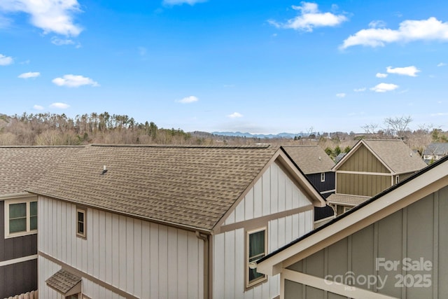 79 Wheeler Rd, Weaverville, NC 28787 - exterior view of a shingled roof, a mountain backdrop, a downspout, and gutters