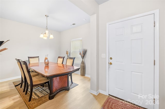 dining room featuring a chandelier and light hardwood / wood-style floors