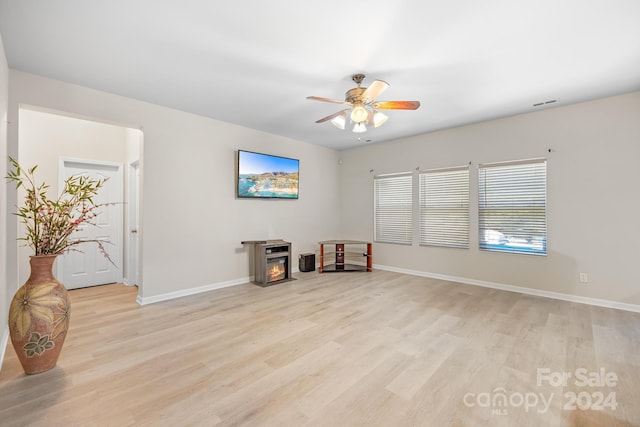 miscellaneous room featuring ceiling fan and light hardwood / wood-style floors