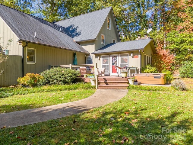 view of front facade with a front yard and a deck