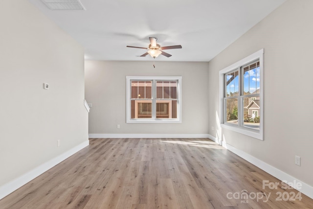 spare room featuring light hardwood / wood-style floors and ceiling fan