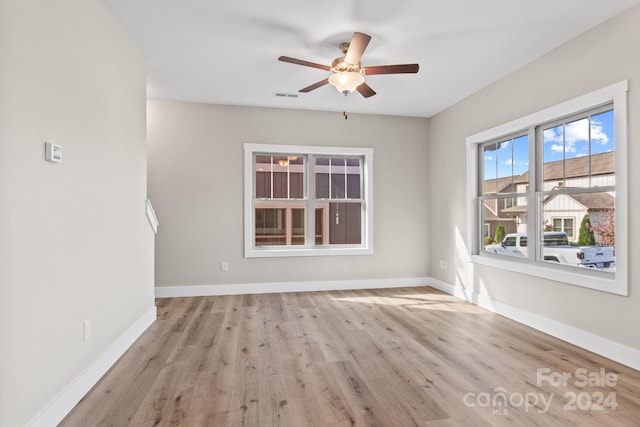 empty room with ceiling fan and light wood-type flooring