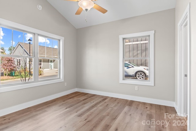 empty room featuring ceiling fan, light hardwood / wood-style flooring, and lofted ceiling