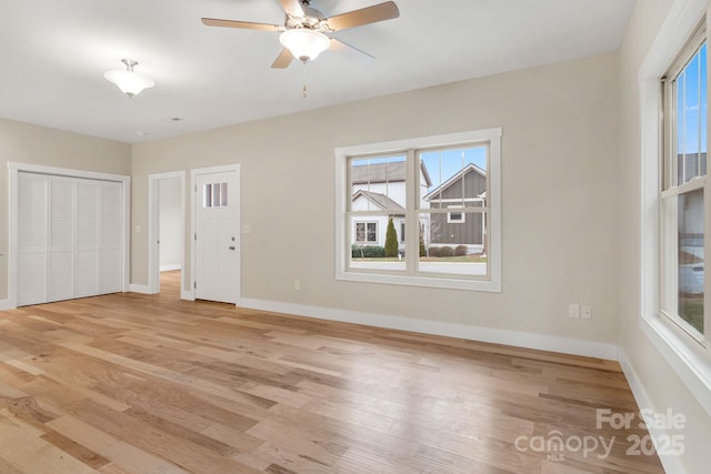 92 Wheeler Rd, Weaverville, NC 28787 - unfurnished living room featuring plenty of natural light, light wood finished floors, baseboards, and ceiling fan