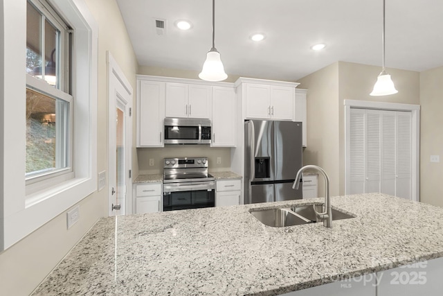 92 Wheeler Rd, Weaverville, NC 28787 - kitchen featuring appliances with stainless steel finishes, a sink, white cabinetry, light stone countertops, and recessed lighting